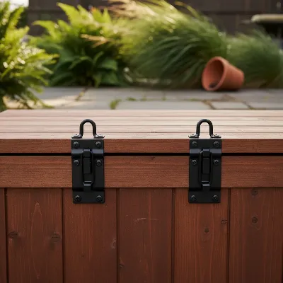 DIY metal latches securing a wooden deck box lid against wind, with a focus on robust hardware